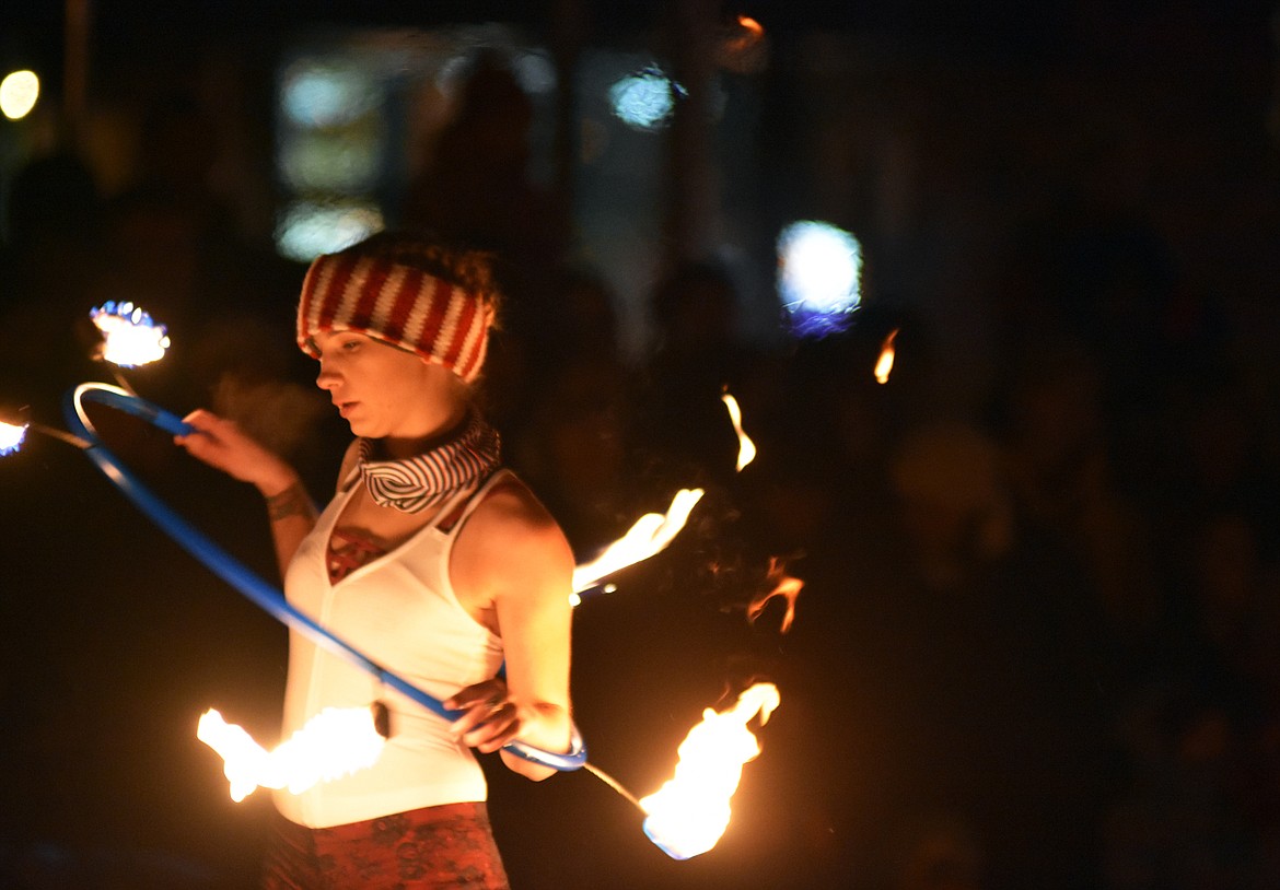 A member of WhiteFire fire dancers performs on Central Avenue Friday night during the Whitefish Christmas Stroll.