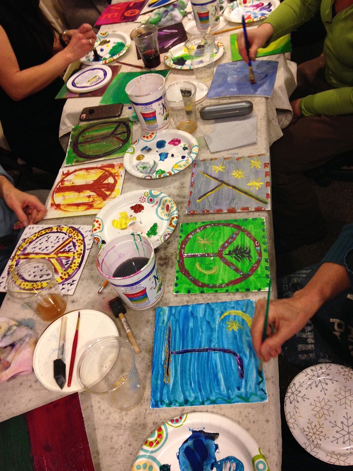 PARTYGOERS COMPLETE their postcards at a "Paint with Passion" party. (Courtesy photo)