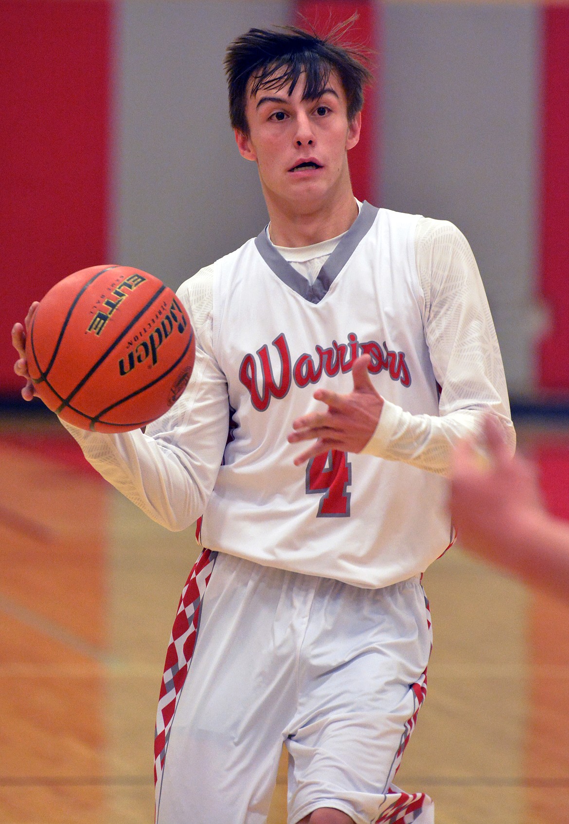 ARLEE GUARD Phillip Malatare does a behind-the-back pass in transition in the first half against St. Regis Thursday night at Arlee High School&#146;s gymnasium. (Jason Blasco/Lake County Leader)