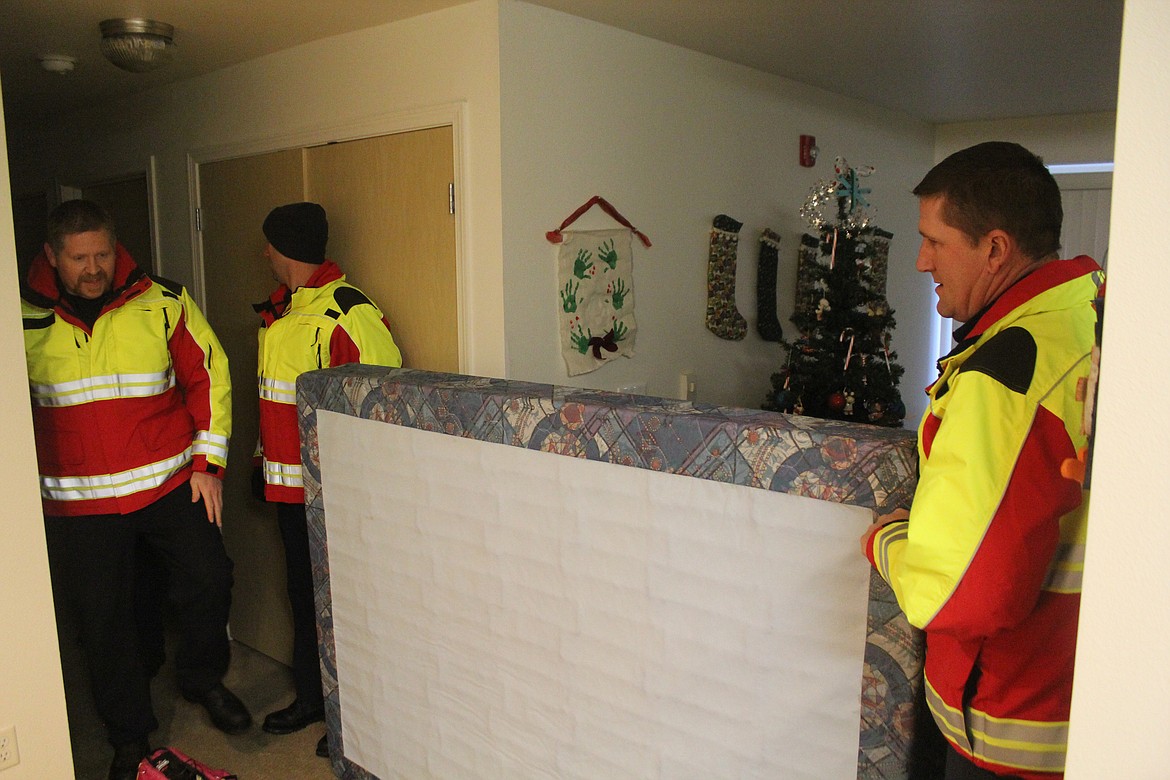 Richard Byrd/Columbia Basin Herald
Moses Lake firefighters deliver a bed to a local family in need Saturday morning.