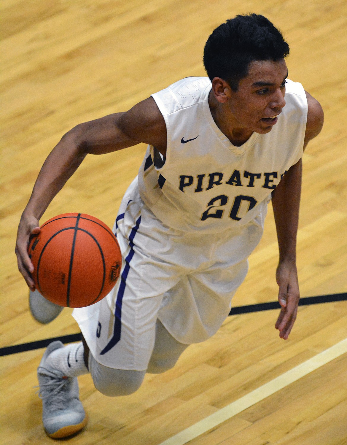 PIRATES GUARD Jaydon Bautista drives the lane in the first half of the non-conference rivalry game Tuesday at Linderman Elementary Gym. (Jason Blasco/Lake County Leader)