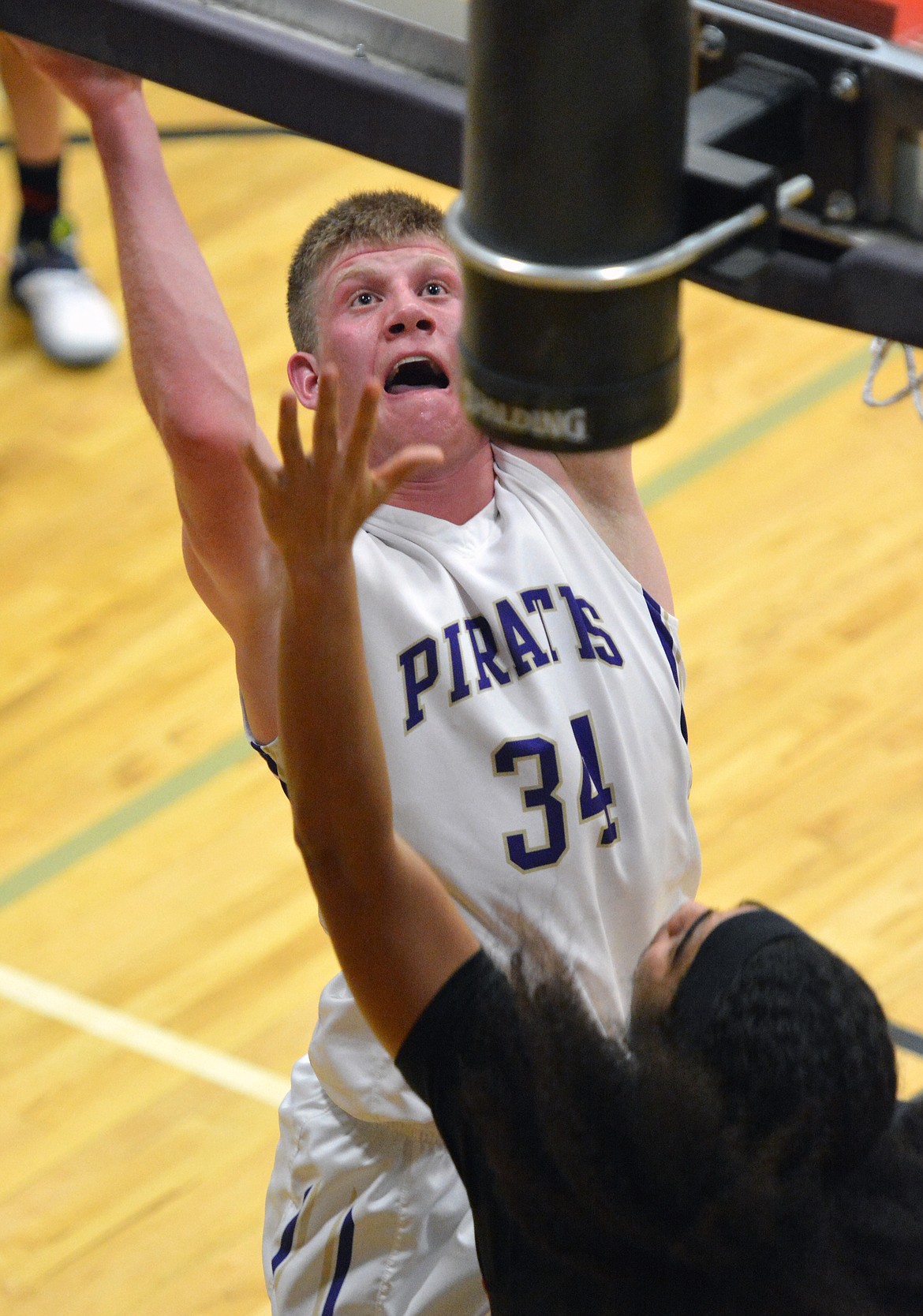 POLSON FORWARD Matthew Rensvold crashes the boards in the first half of the Ronan, Polson non-conference rivarly. (Jason Blasco/Lake County Leader)