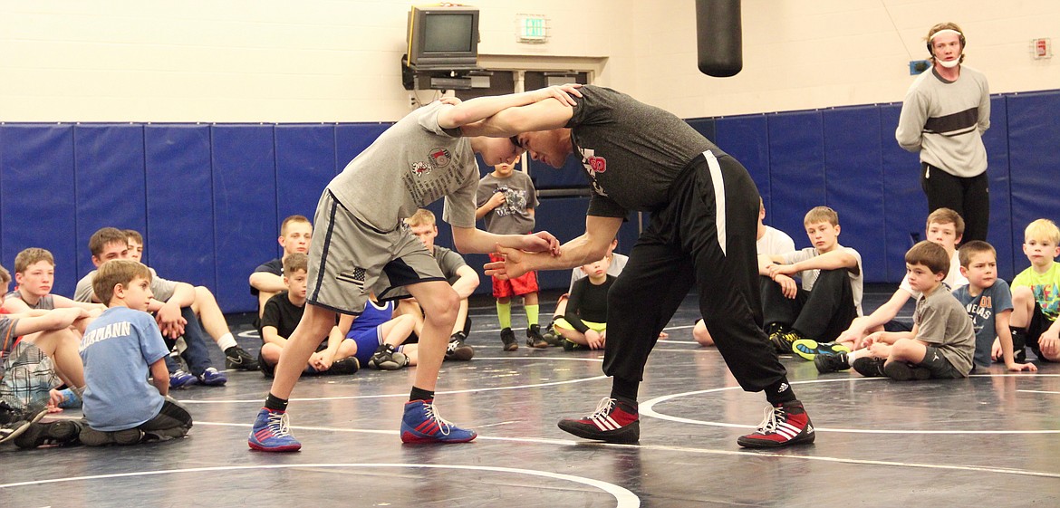 &#151;Photo by DAC COLLINS
Members of the Bonners Ferry Wrestling Club (BFWC) watch and learn as Adam Hall works with a young wrestler during the free wrestling clinic that took place at Bonners Ferry High School on Dec. 23. According to his mother Linda Hall, Adam&#146;s clinic has become such a hit that many wresters outside the BFWC community have been asking to participate. However, this year, as in years past,  it was held explicitly for members of the local wrestling club.