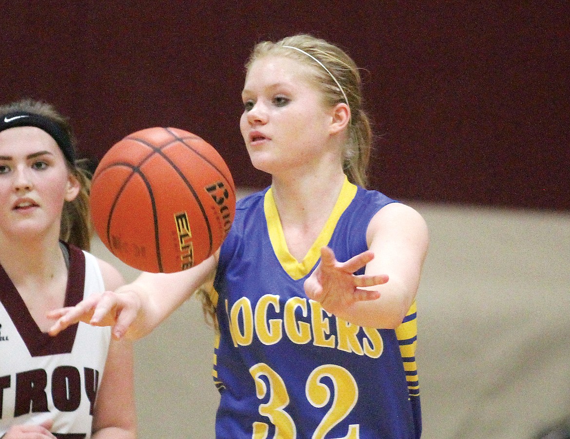 Junior Khalyn Hageness passes to Alli Collins in third quarter Tuesday vs. Troy. Lady Loggers over Lady Trojans in a squeaker 47-46. (Paul Sievers/TWN)