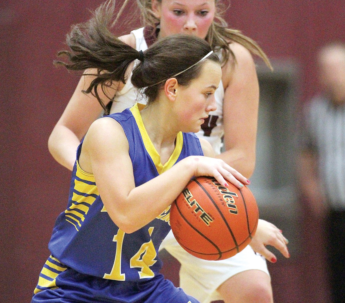 Senior Madisen Monigold drives past the watchful eye of Allie Brown in fourth quarter vs. Troy Tuesday. (Paul Sievers/TWN)