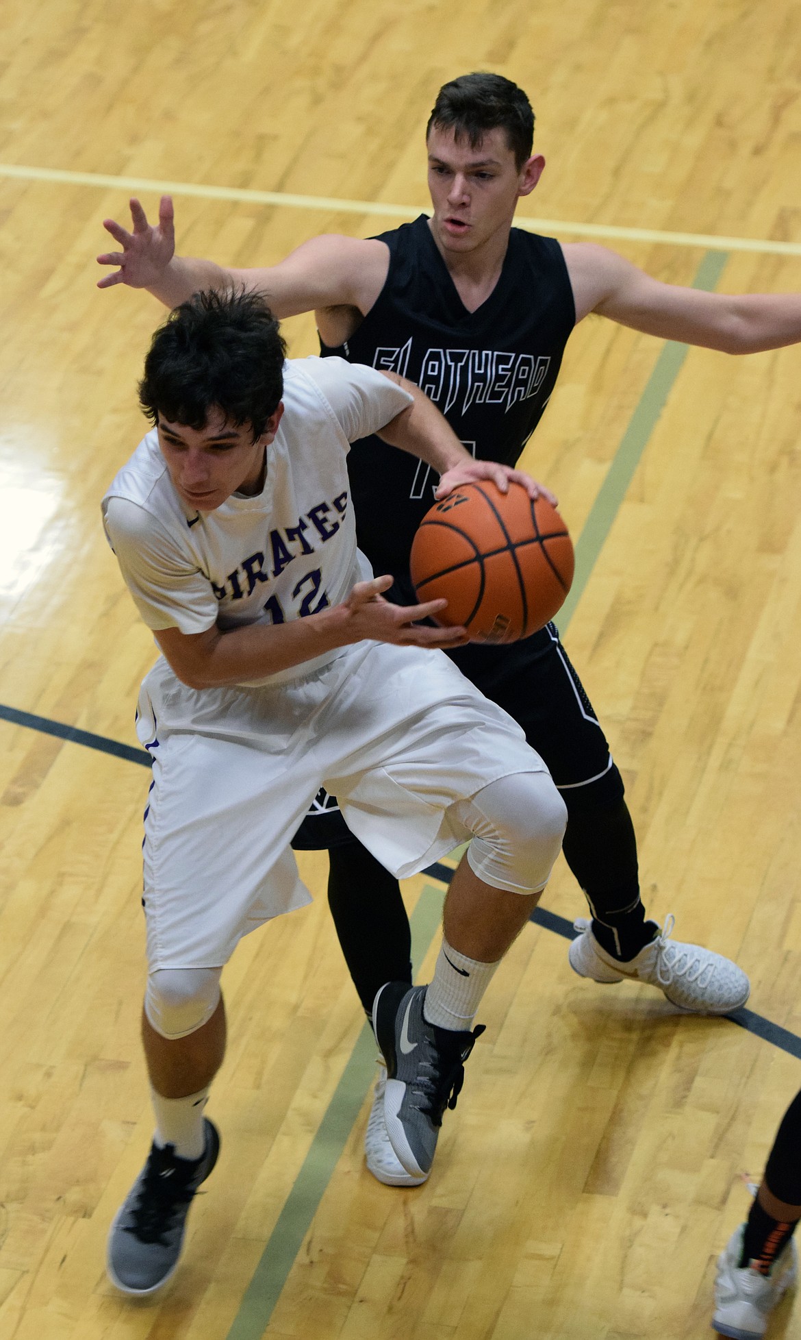 POLSON HIGH School guard J&#146;von Johnson slashes through the Flathead defense in the first half of the non-conference game against Flathead Thursday night at Linderman Elementary. (Jason Blasco/Lake County Leader)