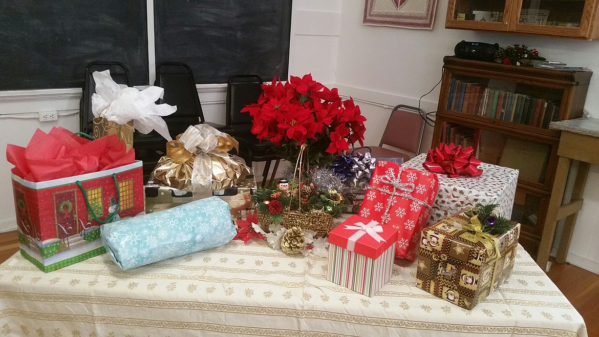 All the women bring gifts to exchange during the annual luncheon at the old DeBorgia school house. (Photo courtesy of The DeBorgia Historic School House Foundation)
