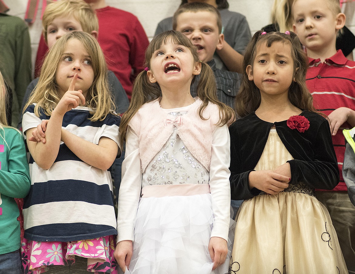 Ruder Elementary School first graders sing during a concert last week. From left is Arbor Traina, Sophie Bauer and Wendy Maldonado. The boy in back with a scrunched up look is Bryan LeFex-Toavs.