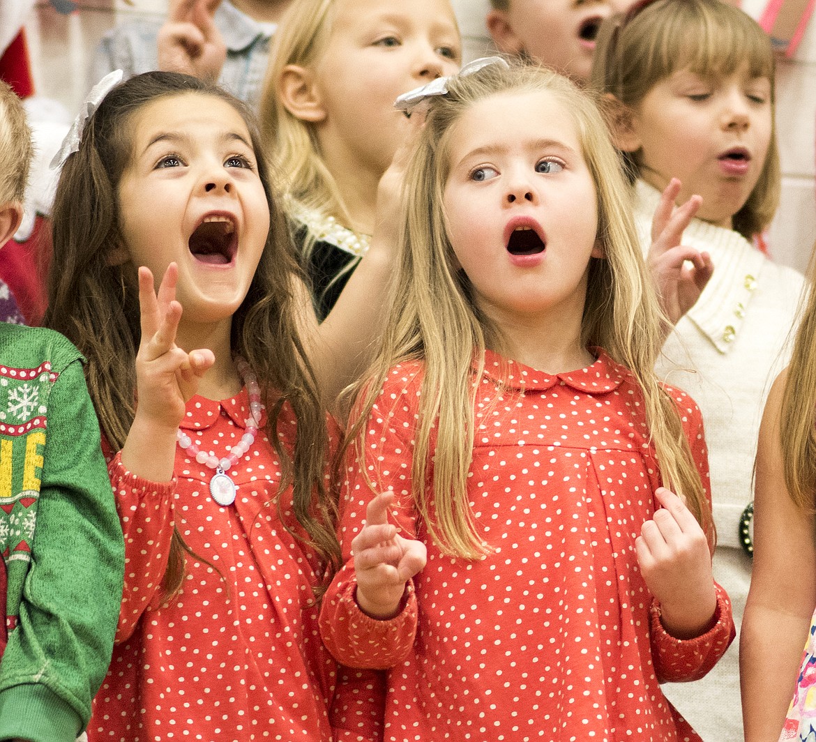 Twins Chloe  and Grace Kinsella sing during a concert at Ruder Elementary School last week. The two are first-graders in Mrs. Robinson's class.