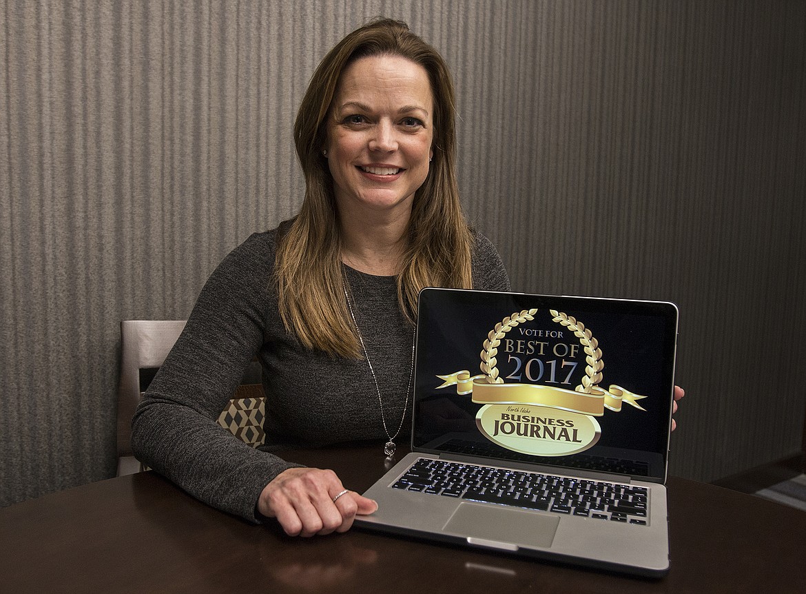 BETHANY BLITZ/Press
Digital sales manager Renee Fast displays the coveted North Idaho Business Journal Best Of 2017 logo in a Press office Tuesday. Vote for your favorite businesses online on www.cdapress.com through Feb. 3.