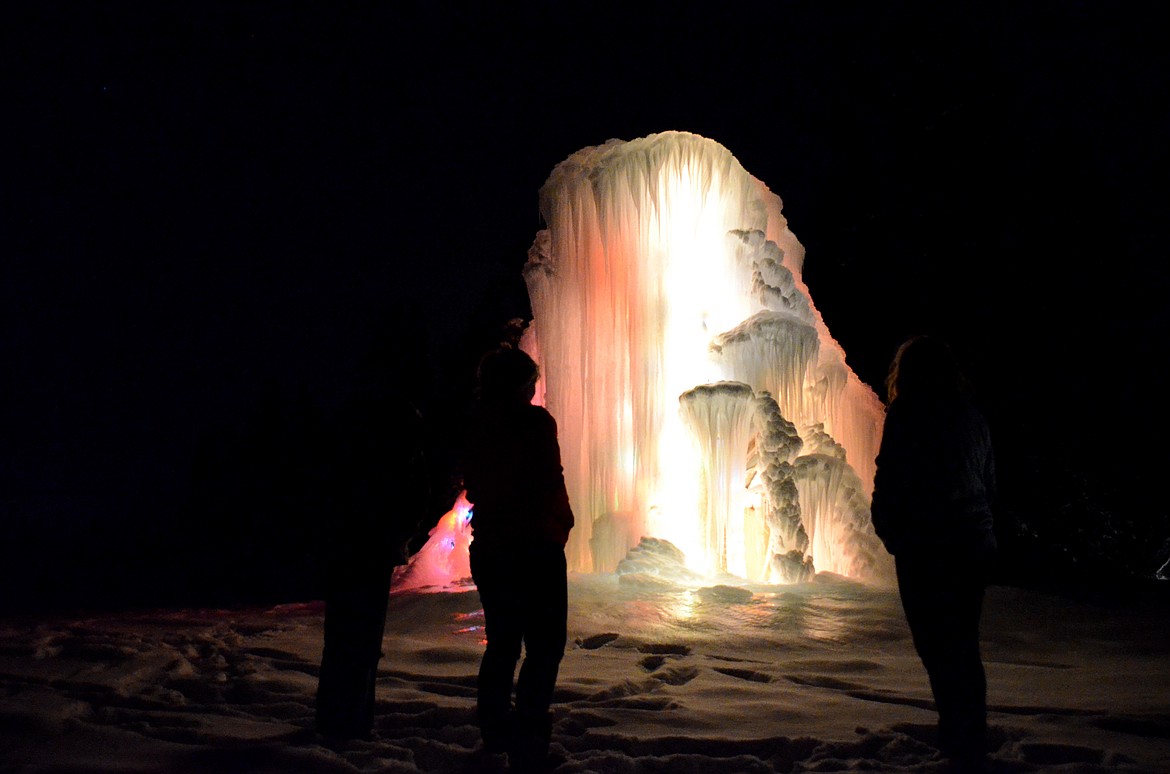 At night, the Olsens&#146; ice castle glows from the Chistmas lights wrapped around the pickup truck beneath the ice. (Seaborn Larson/Daily Inter Lake)