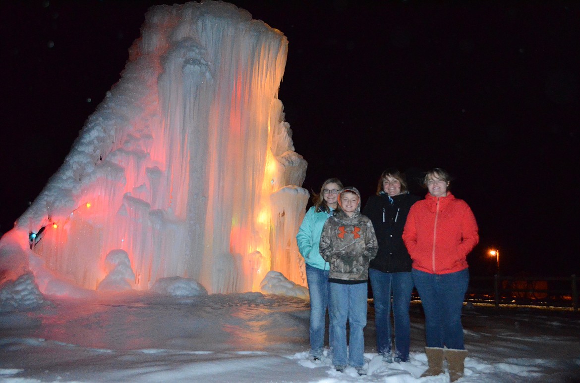 FROM LEFT, Shelby, Dawson, Angie and Candice Olsen stand beside their 20-foot ice castle on Thursday evening near Helena Flats Road. (Seaborn Larson/Daily Inter Lake)