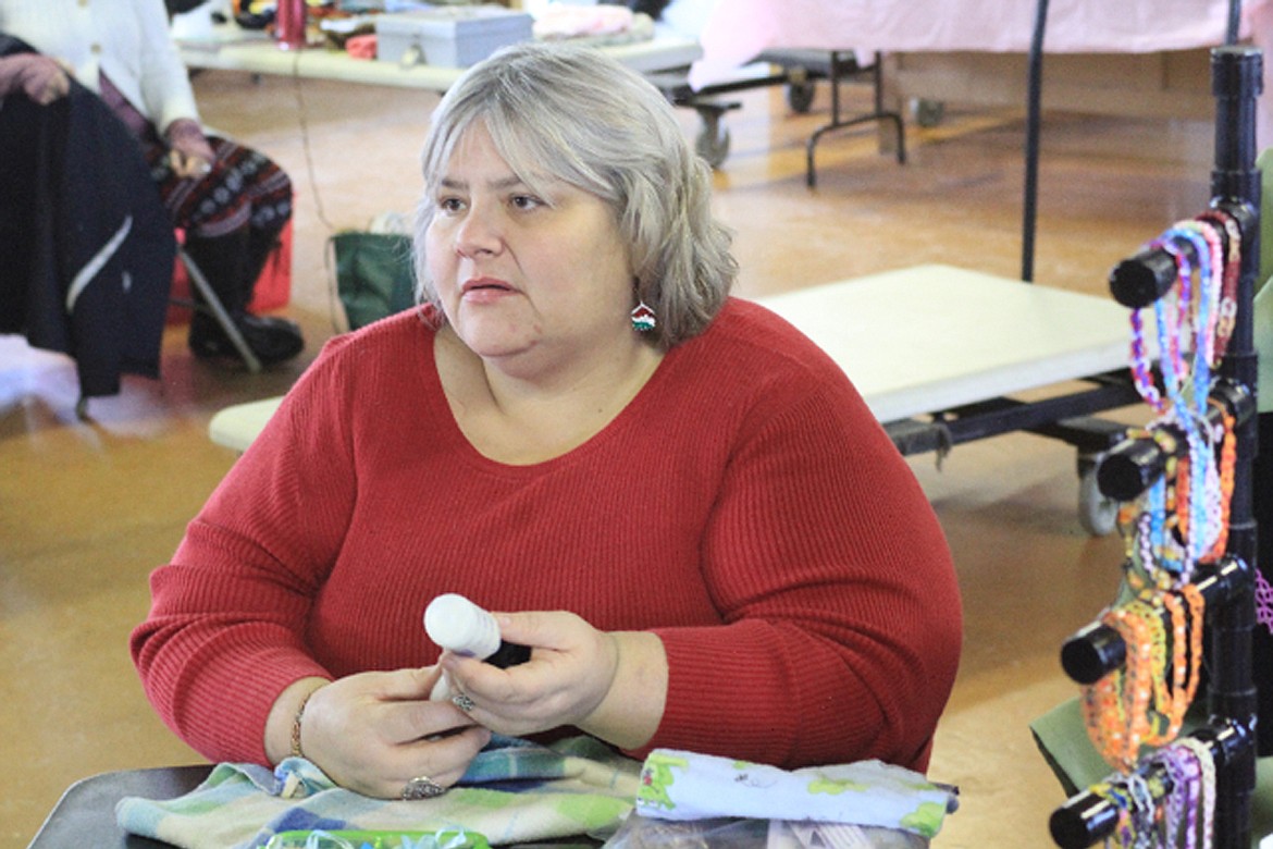 A WOMAN presents some of her work at the Sanders County community market on Saturday. (Douglas Wilks/Clark Fork Valley Press)