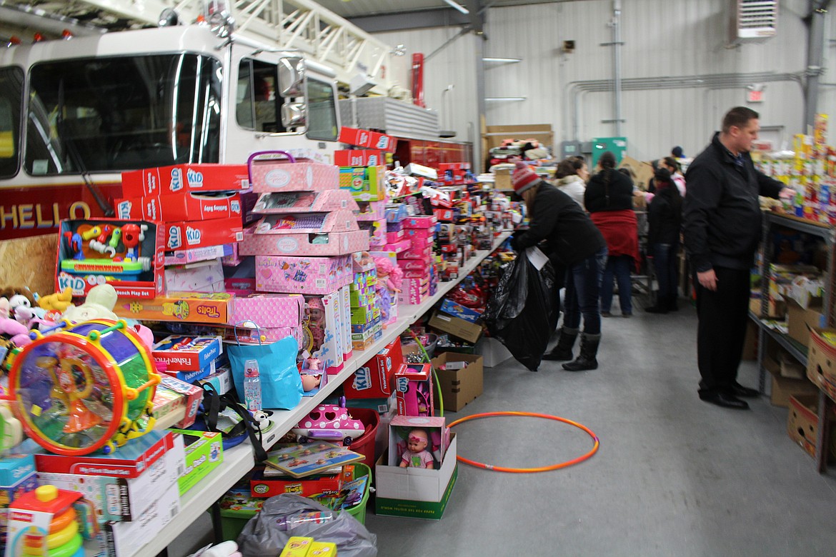 Chanet Stevenson - Donations of toys and food items fill the Adams County Fire Station during the annual Othello Community Christmas Basket Program last saturday.