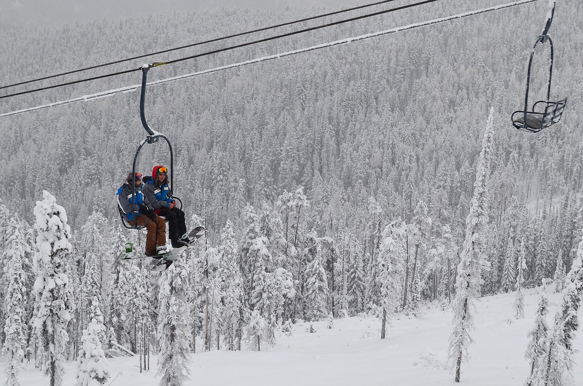 Blacktail Mountain employees ride the lifts during opening day on Dec. 9.