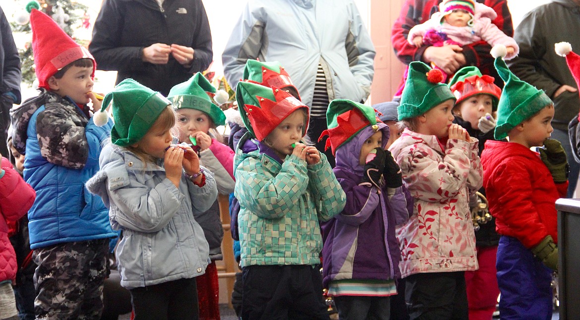 &#151;Photo by DAC COLLINS
Led by Angela McElmurry, 17 preschoolers from Rainbow Preschool sing Christmas carols for Bonners Ferry Herald staff members on Monday. The carolers visited numerous downtown businesses, singing and playing kazoos, until their little feet were tuckered out.