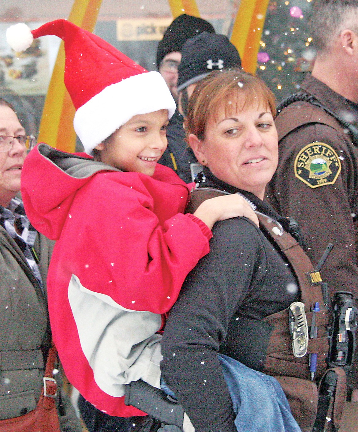 Sheriff&#146;s Deputy Jessica Vanderhoef giving a kid a lift into McDonald&#146;s during the fourth annual Shop With a Cop. (Bethany Rolfson/TWN)