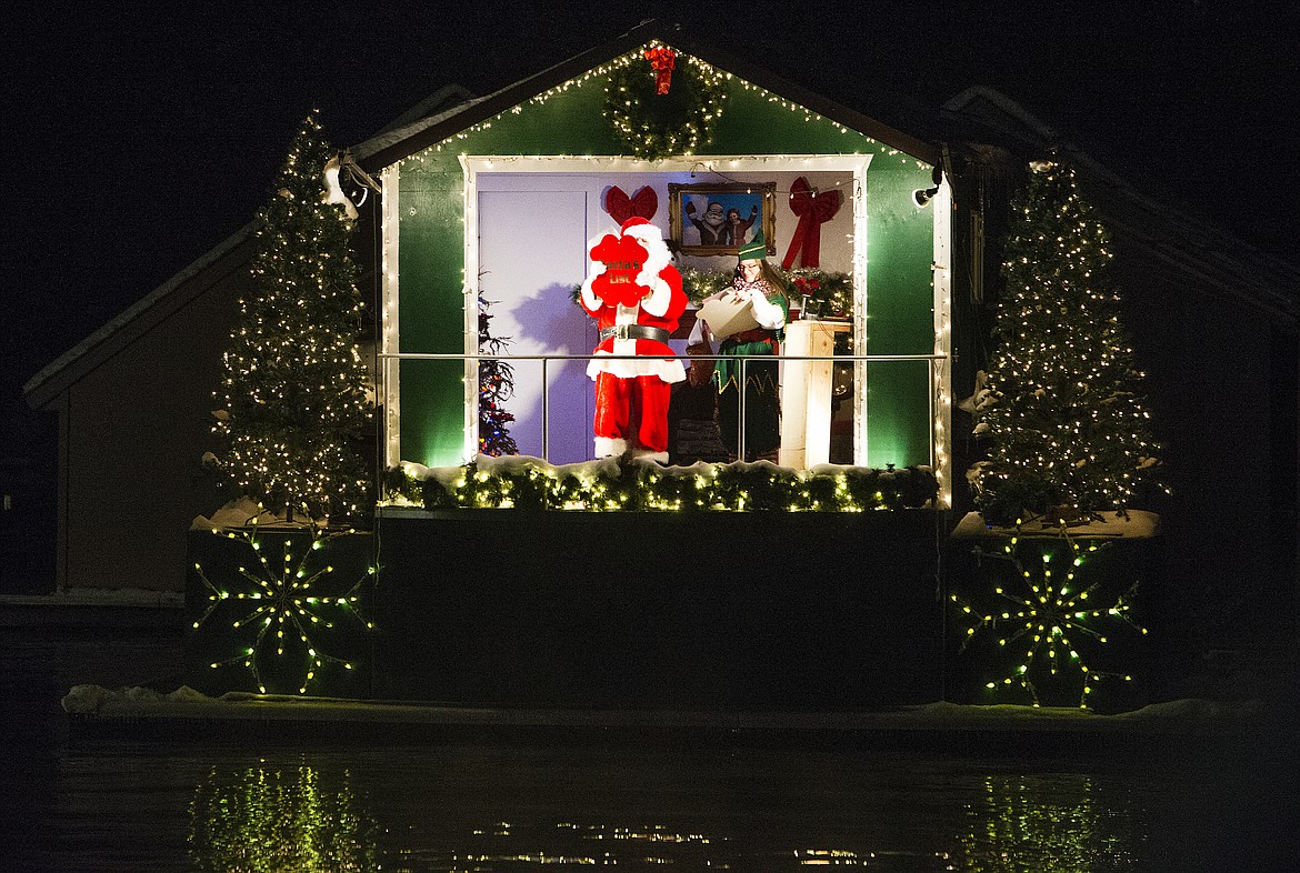 LOREN BENOIT/Press
Santa reads a special letter to Raymond Pearson&#146;s girlfriend, Michelle Beck, Saturday night at the North Pole.