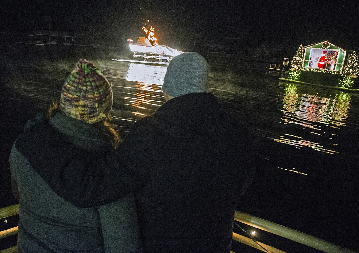 Raymond Pearson and Michelle Beck watch a Holiday Light Show during a cruise to the North Pole Saturday night. (Loren Benoit/Coeur d&#146;Alene Press)