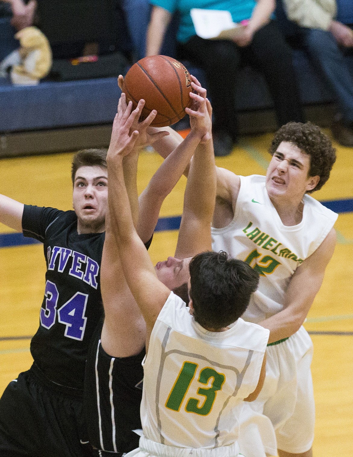 LOREN BENOIT/Press
Lakeland&#146;s Jared Cysewski (12) and Dylan Vahey (13) jump for the offensive rebound while Columbia River defenders Spencer Black (34) and Nathan Hockhalter try to gain possession of the basketball during Friday&#146;s game at Lake City High School.