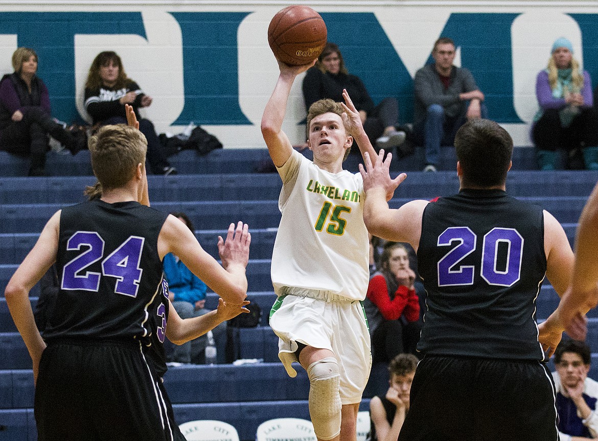 LOREN BENOIT/Press

Lakeland guard Kaden Davis shoots a three-pointer in front of Columbia River defenders Jack Armstrong (24) and Nathan Hockhalter (20) during Friday&#146;s game at Lake City High School.