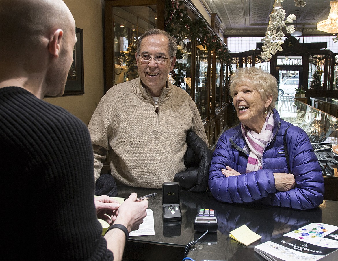 BETHANY BLITZ/PressRich and Ginny Semler, from Liberty Lake, stopped by Clark&#146;s Diamond Jewelers Friday to exchange the necklace and earrings Rich got for Ginny for her birthday. The jewelry store is running a promotion where people who bought anything in the store between Black Friday and Christmas Eve can get their money back if it snows three inches or more in Coeur d&#146;Alene on New Year&#146;s Eve.