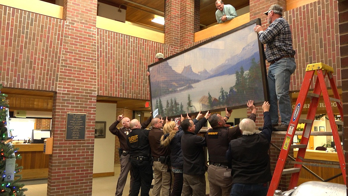 A TEAM of workers install a mural at the Lake County Courthouse in Polson. (Photo courtesy of Ed Gillenwater)