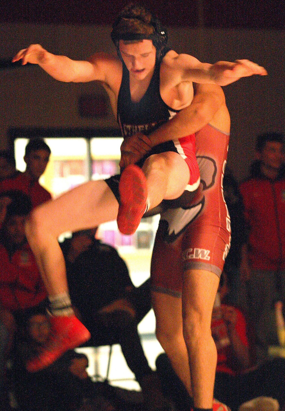 Rodney Harwood/Columbia Basin Herald - Othello's Sterling Roylance maintains his balance as Toppenish's Miguel Castellano whips him around in the 145-pound match.