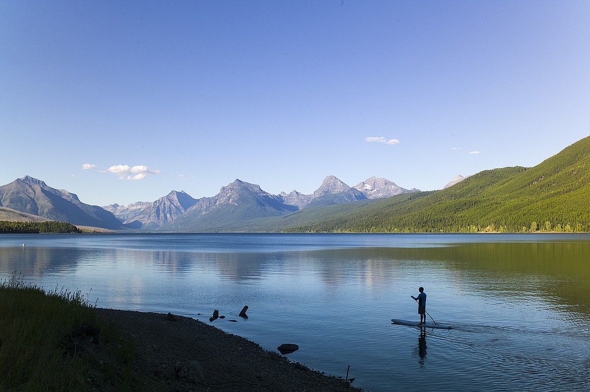 A paddleboarder glides on Lake McDonald last week on a calm summer evening.