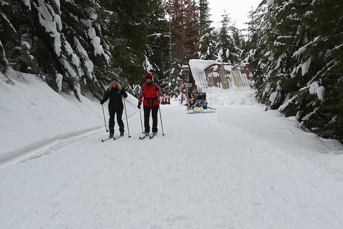 DEVIN HEILMAN/Press
Kathi Abate of Coeur d'Alene, left, and Linda Barnes of Hayden sail over snowy trails on cross-country skis Saturday at the Fourth of July Pass Recreation Area.