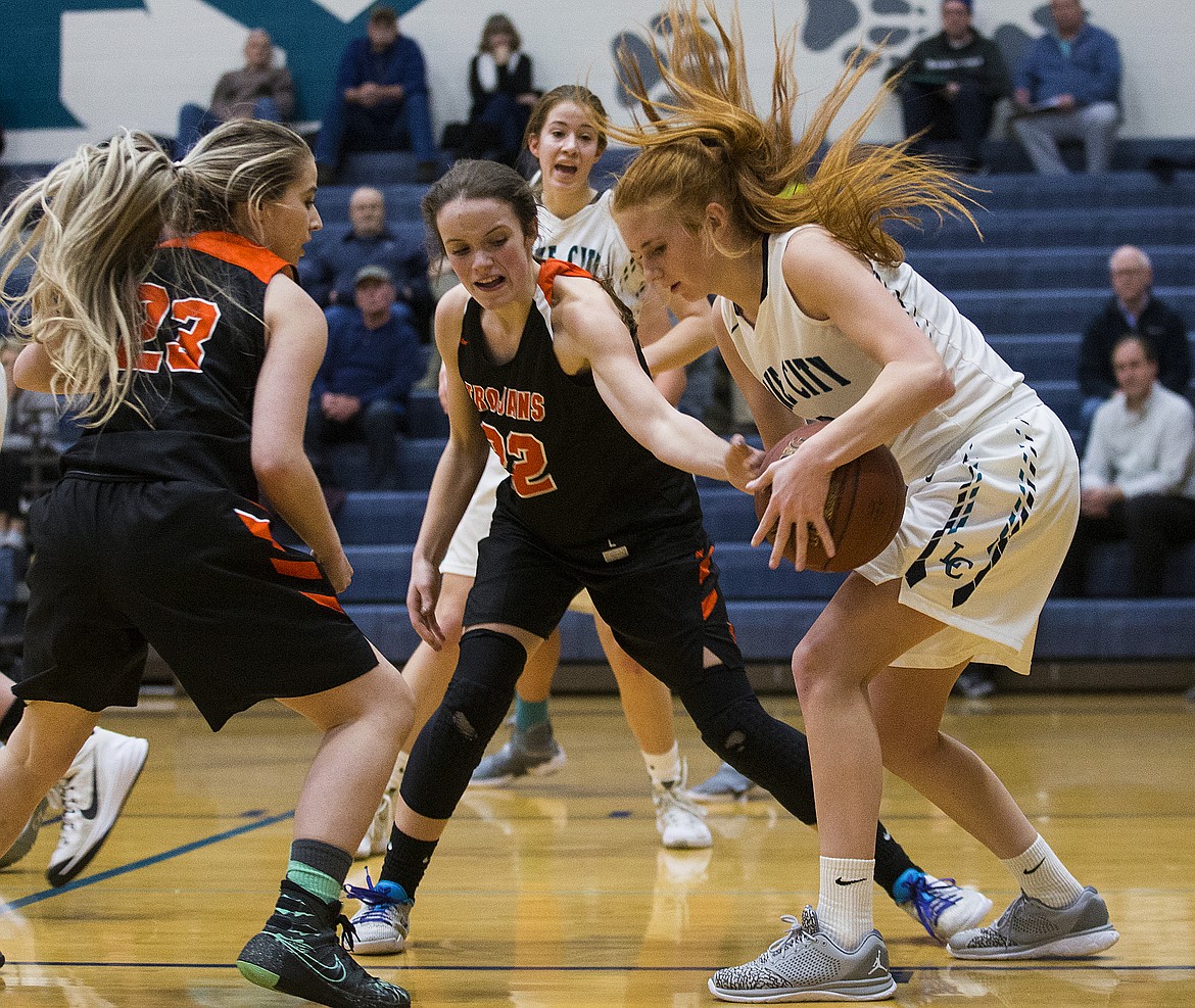 LOREN BENOIT/Press

Jacksen McCliment-Call of Post Falls tries to pry the basketball away from Payton Barber during Thursday&#146;s game at Lake City High School.