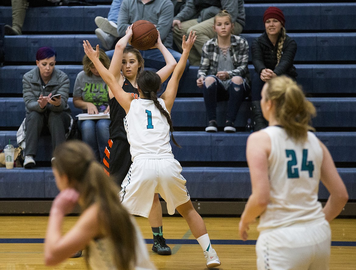 LOREN BENOIT/Press

Briauna Robinson looks for a teammate while defended by Ashlynn Allen during Thursday&#146;s game at Lake City High School.