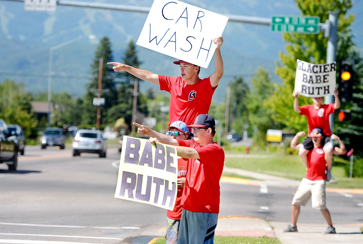 Austyn Andrachick, front to back, Hunter Palmer, and Trenton Tyree (on Palmer&#146;s shoulders) and other team members wave to cars to invite them to their fundraiser carwash on Tuesday afternoon, June 28, in Whitefish. Ironically the day the community woke up to learn the bleachers at the Sapa-Johnsrud Babe Ruth Fields has been destroyed in a fire the team members were already scheduled to do the fundraiser at the Cenex Zip Trip to help with travel expenses for tournaments. &#160;&#160;Babe Ruth President Ray Queen said the field doesn&#146;t have any structural insurance. That means the costs of repairs will have to be met by the league. Fundraisers are still in the discussion phase but there is a GoFundMe page through which the league is trying to raise $30,000.&#160;People can donate by visiting:&#160;https://www.gofundme.com/sapa-johnsrud(Brenda Ahearn/Daily Inter Lake)