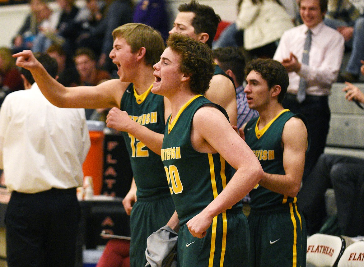 Whitefish senior Tucker Blake (20) and the rest of the Bulldog bench celebrate Dillon Botner's made free throw on the front end of a one-and-one during the final seconds of  overtime of the Bulldog's 49-46  win in Flathead on Friday. (Aaric Bryan/Daily Inter Lake)