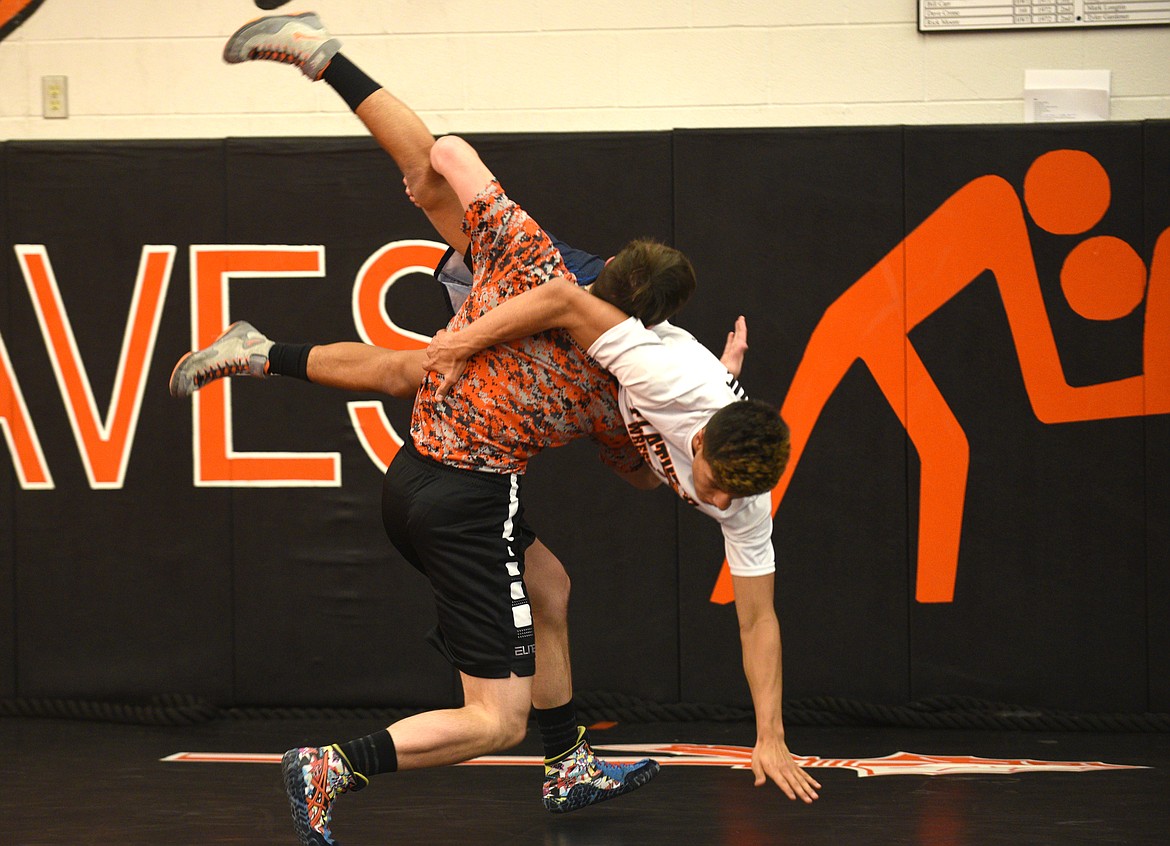 Flathead wrestler Payton Hume takes down Trae Vasquez during drills at practice on Thursday. (Aaric Bryan/Daily Inter Lake)