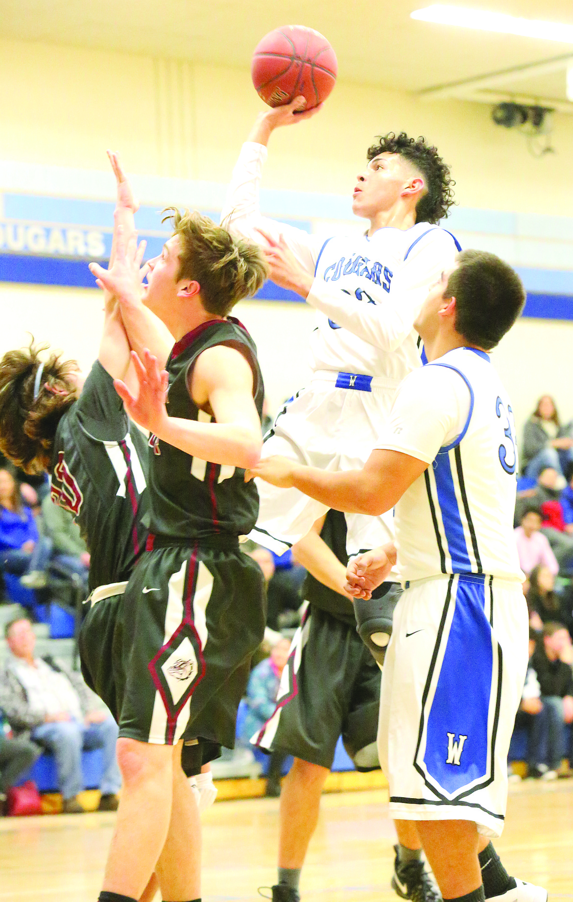 Connor Vanderweyst/Columbia Basin Herald
Warden wing JR Delgado skies for a basket against Okanogan.