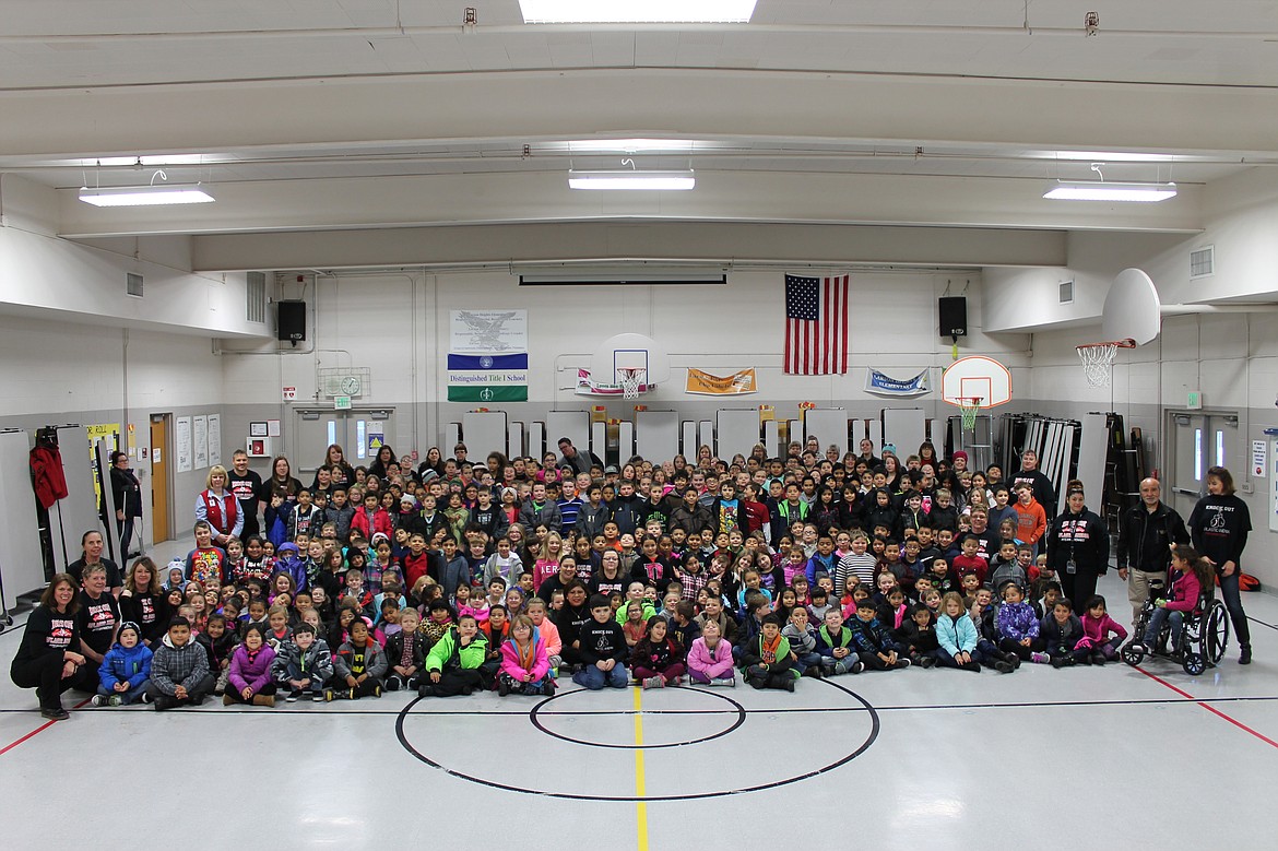 Charles H. Featherstone/The Columbia Basin Herald
All of the students and faculty of Larson Heights Elementary gathered in the gym to welcome Michael Owen (front row, center, in the black shirt) back after nearly a year of treatment for aplastic anemia and recovery from a bone marrow transplant.