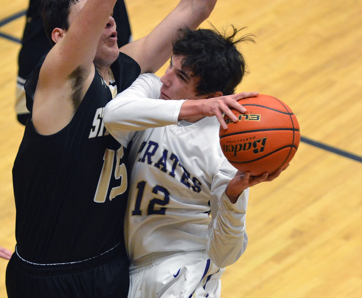 POLSON PIRATE GUARD J&#146;Von Johnson positions himself for a shot at the basket against Stevensville forward Dalton Bragg in the first half of the non-conference game Thursday night at Linderman Elementary. (Jason Blasco/Lake County Leader)