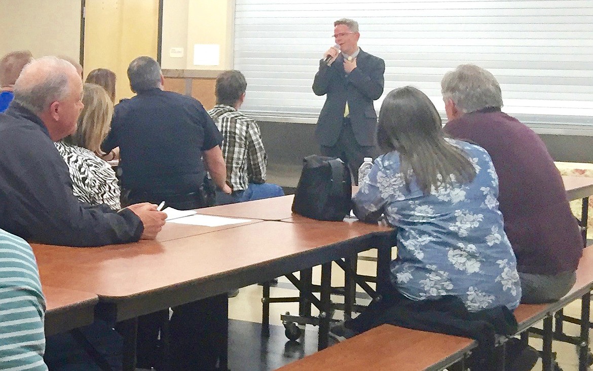 Ted Escobar/The Sun Tribune - Roger Trail chats at head of tables with community members during the community forum held for him earlier this month.