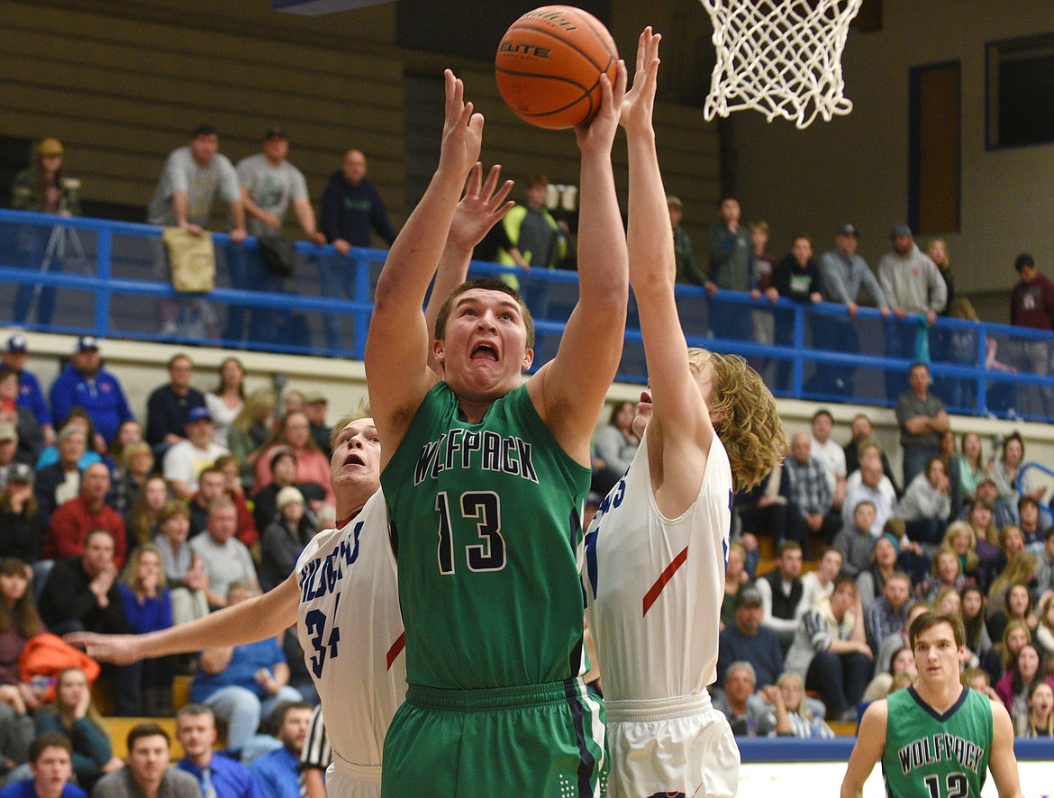 Glacier senior Jaxen Hashley goes up strong for a basket during the first quarter against in Columbia Falls on Thursday. (Aaric Bryan/Daily Inter Lake)