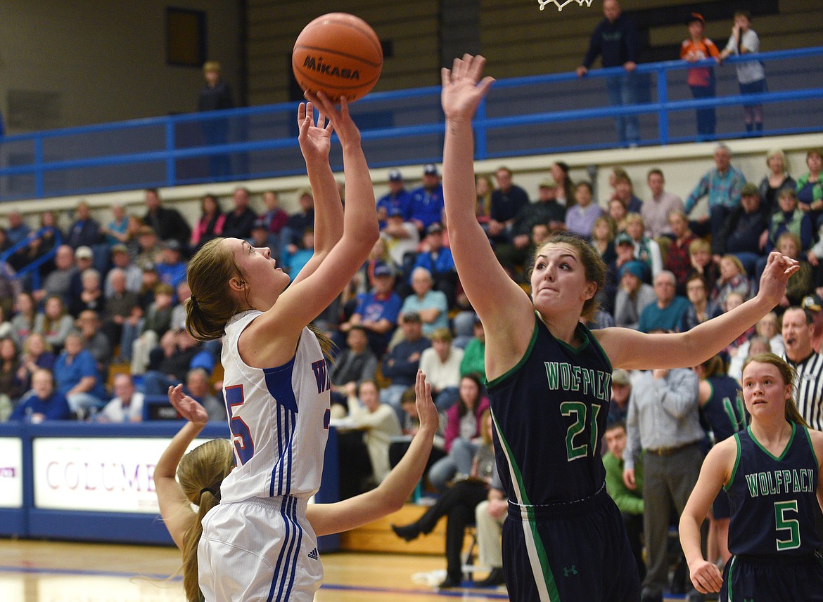 Columbia Falls guard Ryley Kehr puts up a shot as Glacier senior Nikki Krueger attempts to block it during the second quarter at Columbia Falls. (Aaric Bryan/Daily Inter Lake)