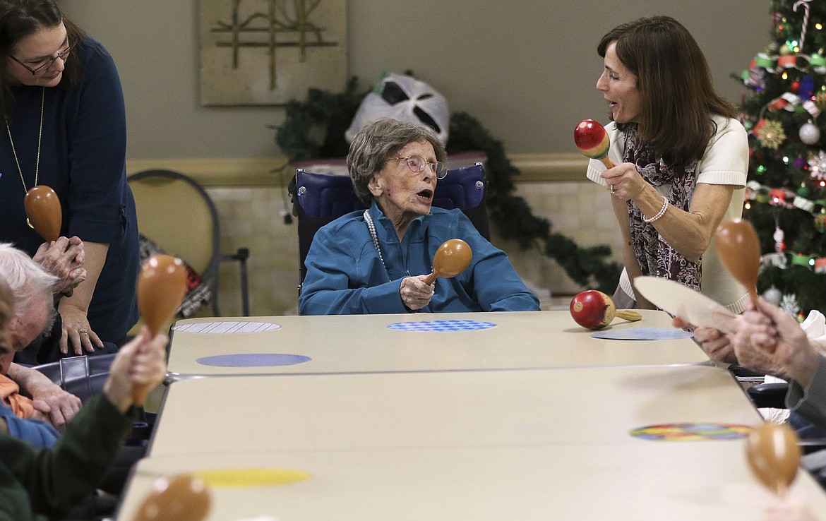 Kevin Wexler/The Record via AP
Adele Dunlap holds a maraca as she looks toward Country Arch Care Center, Activities Assistant, Kim Bocko, in Pittstown, N.J. The activity is performed at the center to engage seniors and help their motor skills. Dunlap, who celebrated her 114th birthday on Dec. 12, 2016, is not just the oldest citizen in the center, she is the oldest American.