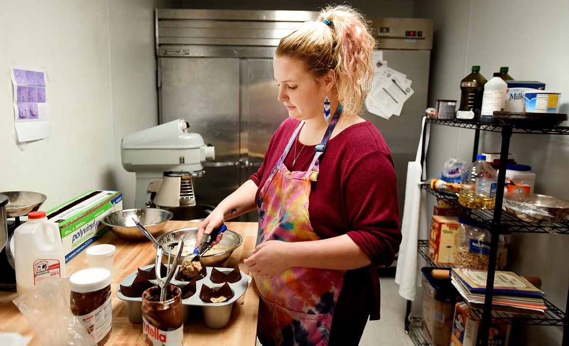 Haley Parker, lead baker at the Whitefish Sweets and Treats in the Stumptown Marketplace in downtown Whitefish, makes banana muffins with Nutella, early in the moring on Dec. 29. (Brenda Ahearn photos/Flathead Journal)