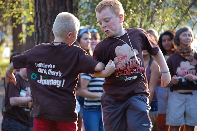 Courtesy photo
Campers Ashton and Owen do-si-do at Camp Journey, where kids who have or are experiencing cancer can cut loose and be kids for a week each summer at no cost.