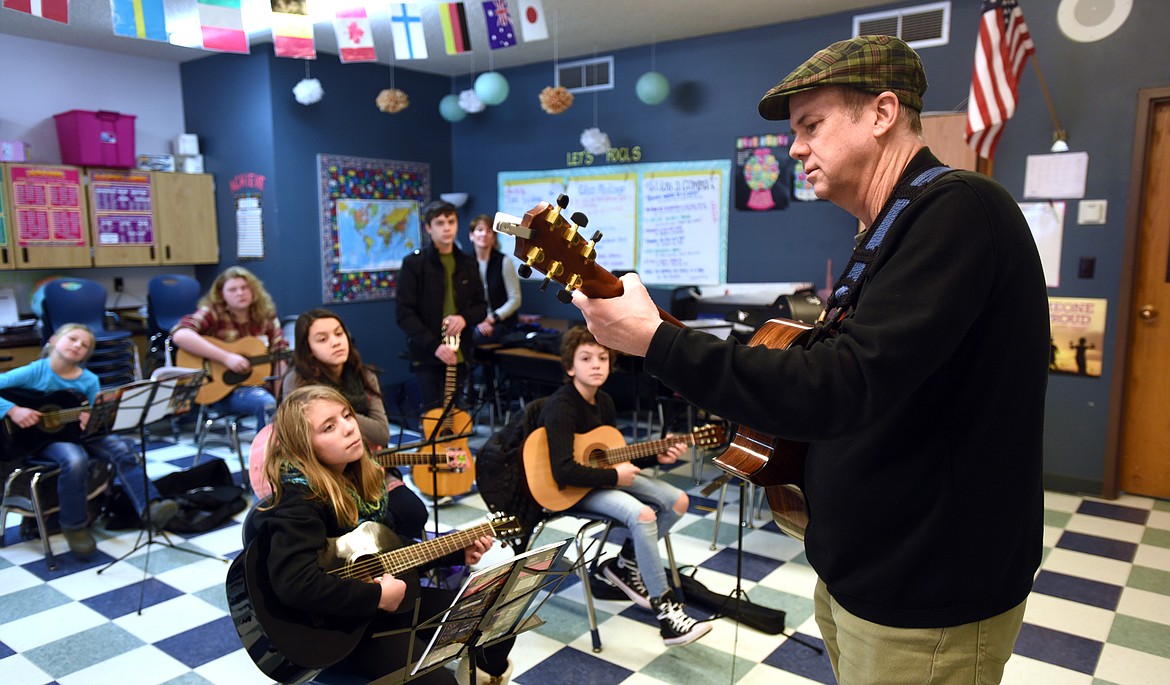 Tim Torgerson teaches chords to students in the Bigfork ACES Beginning Guitar Class on Monday, Jan. 9, at the Bigfork Middle School. The class is part of session two of the program which is available in part due to a partnership with the Crown of the Continent Guitar Foundation. (Brenda Ahearn/Daily Inter Lake)
