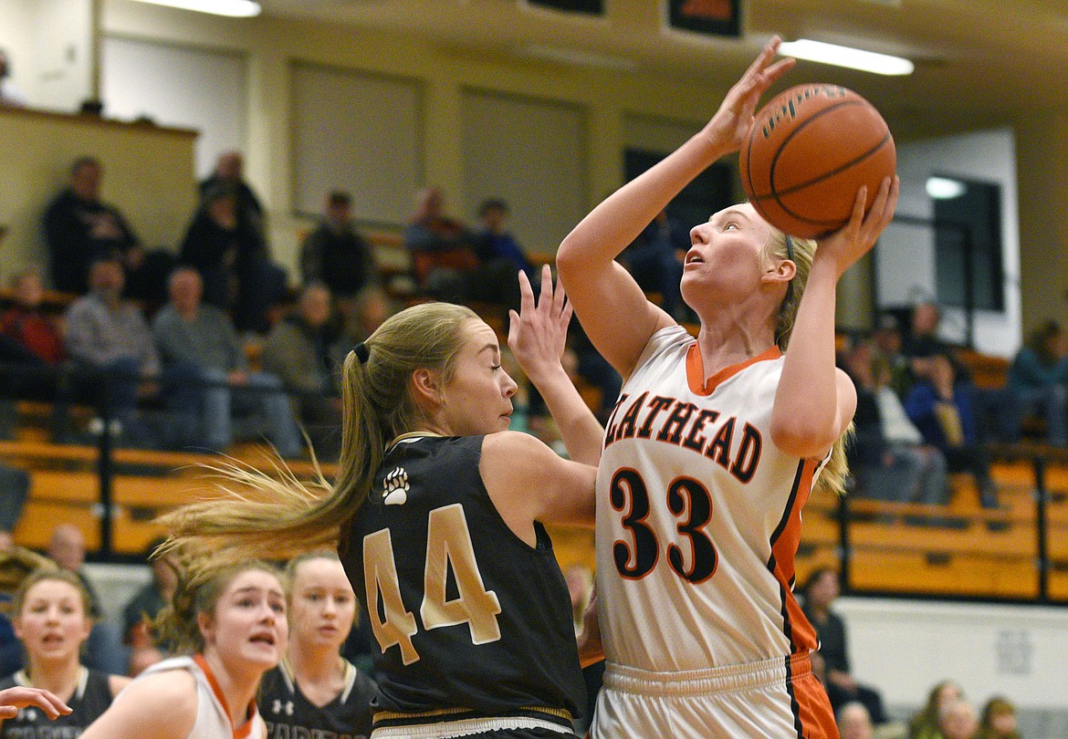 Flathead guard Tiana Johnson puts up a shot after pulling down a rebound during the second quarter at Flathead on Friday. (Aaric Bryan/Daily Inter Lake)