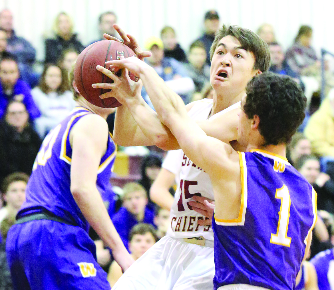 Connor Vanderweyst/Columbia Basin Herald
Moses Lake's Evan McLean (white) fights to get off a shot against Wenatchee defender Matt Springer (1).