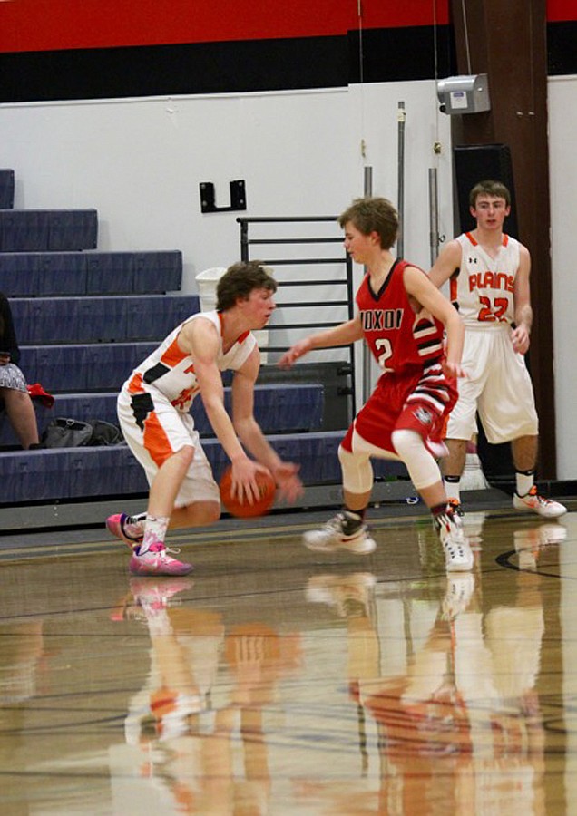 RYAN OVITT (with ball) puts a move on Noxon&#146;s Logan Wood (2) as his Plains teammate, Alec Cole (22), looks on. (Douglas Wilks/Clark Fork Valley Press)