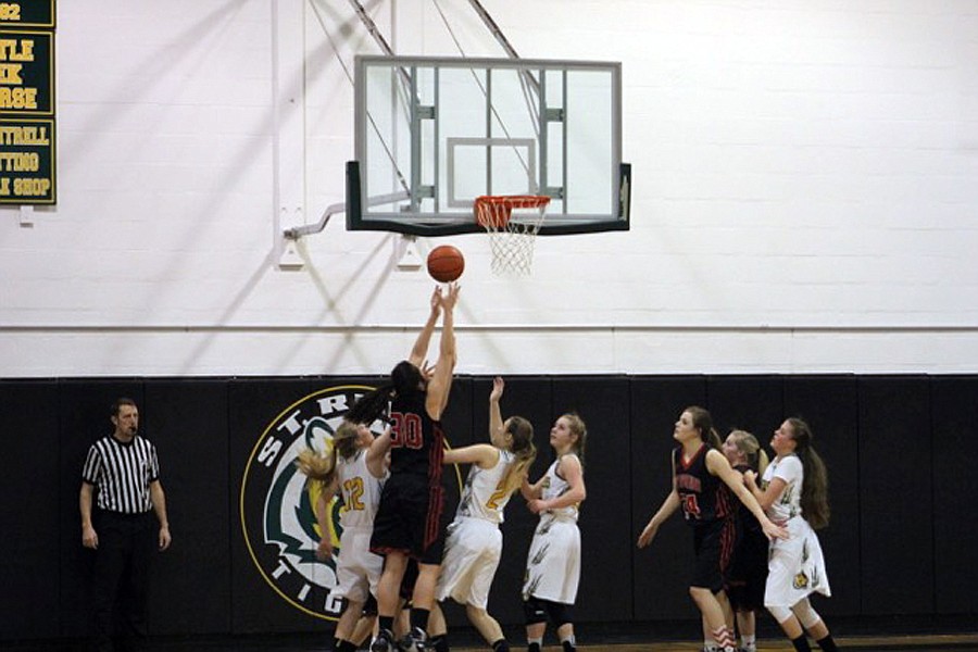 HOT SPRINGS' McKenzie Cannon (30) rises above three St. Regis defenders on Saturday. (Kathy Woodford/Mineral Independent)