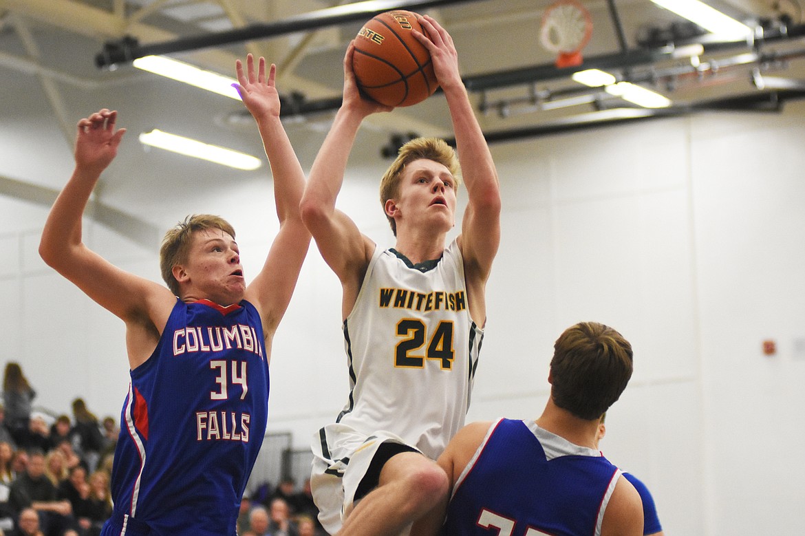 Sawyer Silliker fights through traffic for a layup during a loss to Columbia Falls Thursday. (Daniel McKay/Whitefish Pilot)